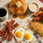 Red Arrow Diner menu prices 2026 breakfast spread with pancakes, eggs, bacon and chicken tenders