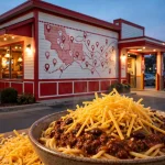 Skyline Chili locations guide: cozy Skyline Chili restaurant storefront at dusk