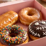Voodoo Doughnut menu prices 2026 colorful glazed doughnuts in pink bakery box